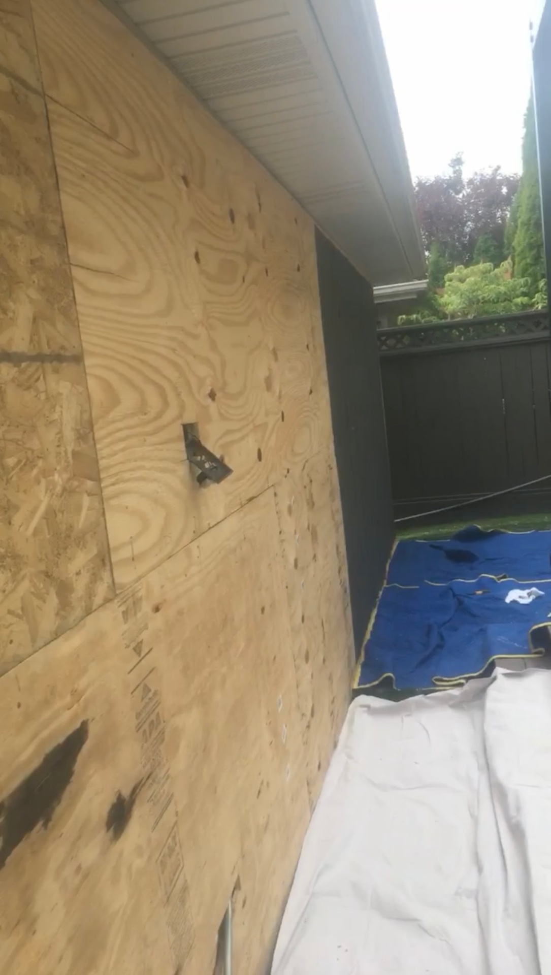Bare plywood wall before exterior finish work