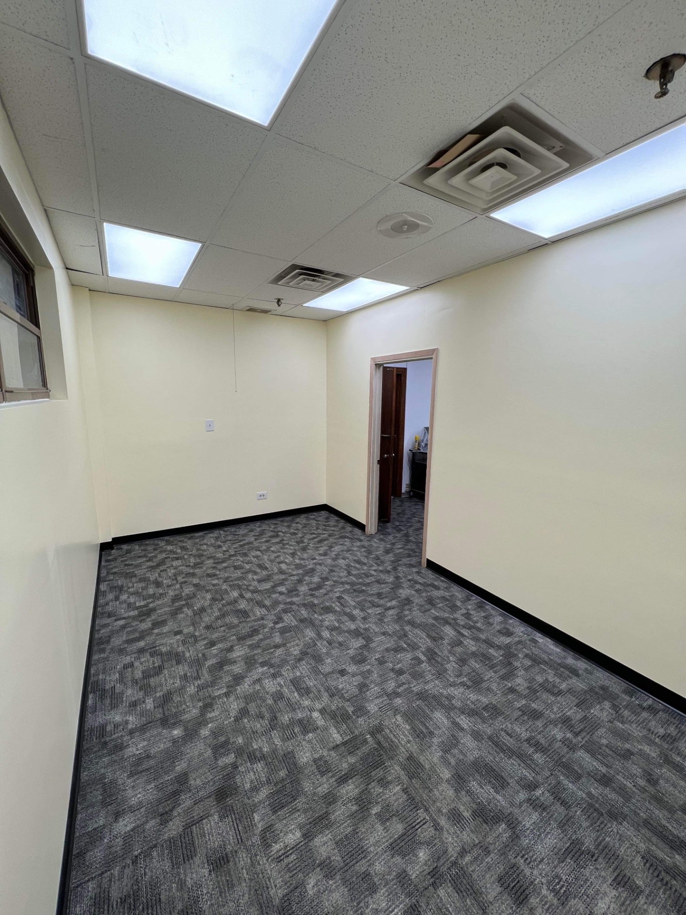 Completed office room with smooth painted walls, trim and clean corners by R&M Drywall