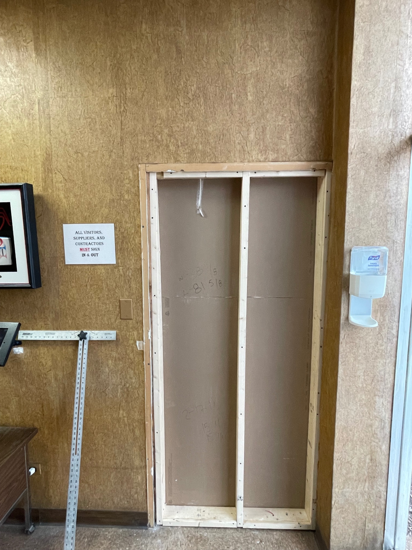 New framed opening with drywall board installed in a commercial entry wall