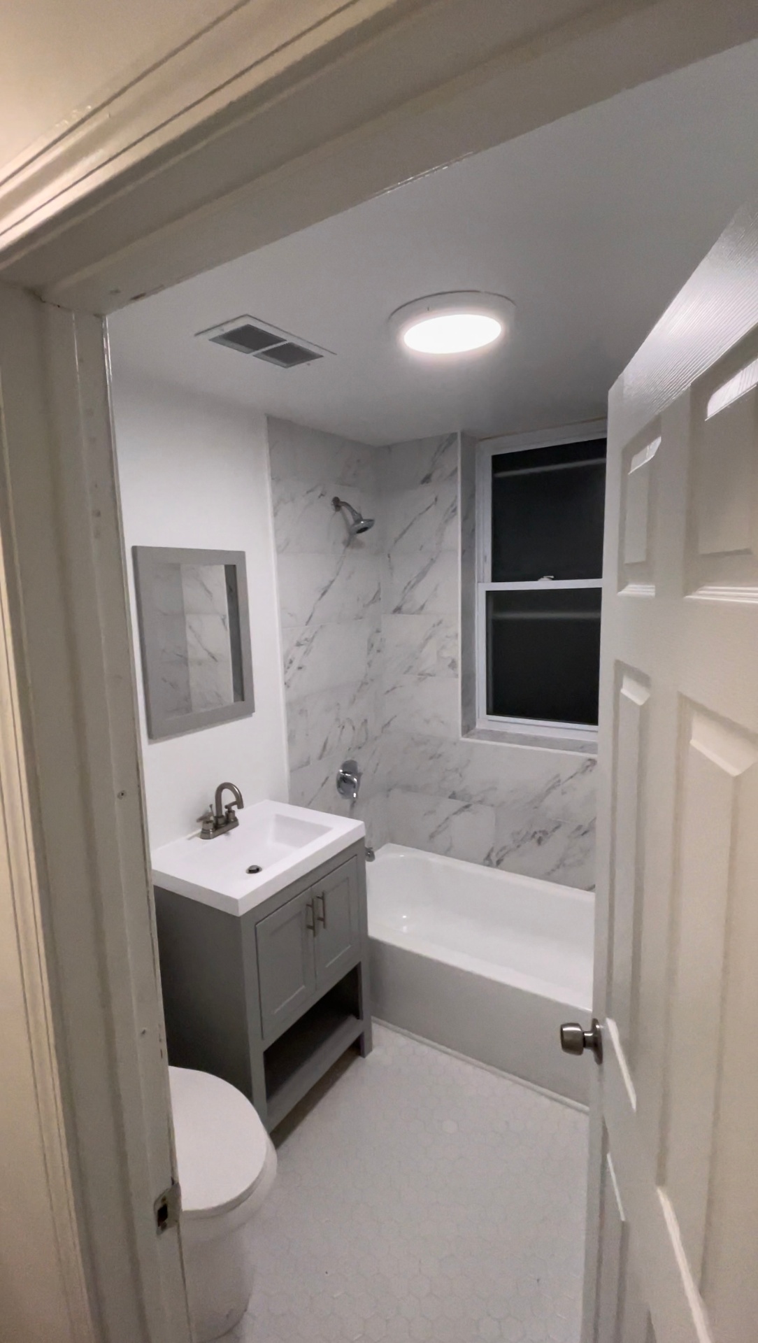 Finished bathroom with smooth painted walls and ceiling completed by R&M Drywall